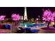 The outdoor pool features decorative trees and city views at night at 200 W Sahara Ave # 2211, Las Vegas, NV 89102