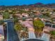 Aerial view of a home with a red tile roof, desert landscaping, and mature shade trees at 2248 Carrizo Way, Henderson, NV 89052