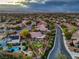Panoramic aerial view of a residential neighborhood with manicured landscaping and putting green at 2248 Carrizo Way, Henderson, NV 89052
