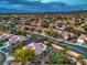 Expansive aerial view of a neighborhood in the desert with palm trees and mature landscaping at 2248 Carrizo Way, Henderson, NV 89052