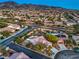 Expansive aerial view showcasing the neighborhood's layout, landscaping, and cul-de-sac homes near mountain views at 2248 Carrizo Way, Henderson, NV 89052