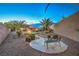 Lush landscaped backyard with stone bench, desert plantings, and integrated landscape lighting at 2248 Carrizo Way, Henderson, NV 89052