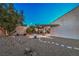 Serene backyard with custom stone pathway, rock landscaping, and mature trees for privacy at 2248 Carrizo Way, Henderson, NV 89052