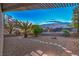Desert landscaped backyard featuring a shaded patio, mature palms, and custom night lighting at 2248 Carrizo Way, Henderson, NV 89052