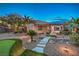 Expansive backyard with synthetic lawn, desert landscaping, and covered patio at 2248 Carrizo Way, Henderson, NV 89052