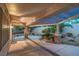 An elegant covered patio features stone columns, a pergola, and manicured landscaping at 2248 Carrizo Way, Henderson, NV 89052