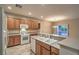 Bright kitchen with white appliances, tile floors, and wood cabinets at 2248 Carrizo Way, Henderson, NV 89052