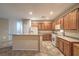 Bright kitchen features wood cabinets, a breakfast bar, and ample counter space for meal preparation at 2248 Carrizo Way, Henderson, NV 89052