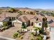 Aerial shot of a single-story home with desert landscaping, a brick-paved driveway, and gated courtyard entry at 2373 Black River Falls Dr, Henderson, NV 89044