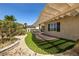 Backyard with covered patio, artificial turf, and tasteful landscaping at 2373 Black River Falls Dr, Henderson, NV 89044