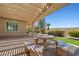 Relaxing backyard patio with decorative stone table and benches, offering a serene outdoor space at 2373 Black River Falls Dr, Henderson, NV 89044