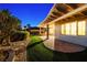 Spacious backyard featuring covered patio, lush landscaping, and stone pathway at 2373 Black River Falls Dr, Henderson, NV 89044