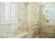 Luxurious bathroom features travertine tile, pebble floor, and a built-in shower bench at 2373 Black River Falls Dr, Henderson, NV 89044