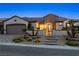 Attractive home featuring desert landscaping, decorative entry gate, and paved driveway at 2373 Black River Falls Dr, Henderson, NV 89044