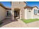 Inviting front entrance with brick archway, decorative stone accents, and manicured landscaping at 2373 Black River Falls Dr, Henderson, NV 89044