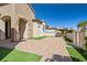 Charming single-story home featuring desert landscaping, a brick-paved driveway, and gated courtyard entry at 2373 Black River Falls Dr, Henderson, NV 89044