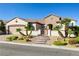 Charming single-story home featuring desert landscaping, a brick-paved driveway, and gated courtyard entry at 2373 Black River Falls Dr, Henderson, NV 89044