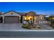 Charming single-story home featuring desert landscaping, a brick-paved driveway, and gated courtyard entry at 2373 Black River Falls Dr, Henderson, NV 89044
