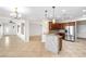 Open concept eat-in kitchen area with wood cabinets and bar area for informal seating at 2373 Black River Falls Dr, Henderson, NV 89044