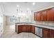 Bright kitchen with stainless steel appliances, a breakfast bar, dark wood cabinetry, and tiled floors at 2373 Black River Falls Dr, Henderson, NV 89044