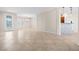 Open-concept living room features tile flooring and neutral tones with modern lighting fixtures at 2373 Black River Falls Dr, Henderson, NV 89044