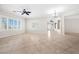 Spacious open floor plan living room with tile flooring, a ceiling fan, and large windows at 2373 Black River Falls Dr, Henderson, NV 89044