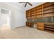 Well-lit office with abundant shelving, custom built-ins and access to other rooms at 2373 Black River Falls Dr, Henderson, NV 89044
