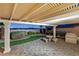 Charming covered patio featuring custom stone table set and built-in outdoor grill at 2373 Black River Falls Dr, Henderson, NV 89044
