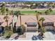 Aerial view of a residential community with lush golf course views and mature palm trees at 2445 Antler Point Dr, Henderson, NV 89074