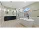Primary bathroom features a soaking tub, glass shower, double sinks, and modern fixtures at 2445 Antler Point Dr, Henderson, NV 89074