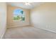 Bedroom with a large window, neutral carpet, and a ceiling fan at 2445 Antler Point Dr, Henderson, NV 89074