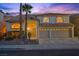 Charming two-story home boasting a tile roof, three-car garage, and professionally landscaped front yard at 2445 Antler Point Dr, Henderson, NV 89074