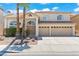 Charming two-story home with a well-manicured lawn, mature trees, and a welcoming three-car garage at 2445 Antler Point Dr, Henderson, NV 89074
