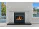 White marble fireplace with black hearth is focal point of the living room and overlooks the backyard at 2445 Antler Point Dr, Henderson, NV 89074