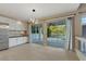 Eat-in kitchen features white cabinets, stainless steel appliances, and large sliding glass doors to backyard patio at 2445 Antler Point Dr, Henderson, NV 89074