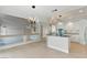 Open concept kitchen with white cabinets, black countertops, and view of the staircase at 2445 Antler Point Dr, Henderson, NV 89074