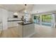 A bright kitchen with white cabinets, stainless steel appliances, island, and sliding glass door at 2445 Antler Point Dr, Henderson, NV 89074