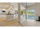 Bright kitchen with white cabinets, black countertops, and view of the pool area at 2445 Antler Point Dr, Henderson, NV 89074