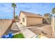 Private backyard showcasing a well-kept lawn, sturdy fence, and desert landscaping at 2744 Ironside Dr, Las Vegas, NV 89108