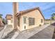 Well-maintained backyard featuring a tiled roof, outdoor door, and textured walls at 2744 Ironside Dr, Las Vegas, NV 89108