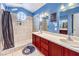 Bathroom featuring double sinks, a large tiled shower with a rain shower head, and plenty of storage space at 2744 Ironside Dr, Las Vegas, NV 89108