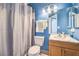 Well-lit bathroom with a shower featuring white tiling, vanity, and coordinated decor at 2744 Ironside Dr, Las Vegas, NV 89108