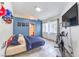 Comfortable bedroom with blue accent wall, natural lighting, and tile flooring throughout at 2744 Ironside Dr, Las Vegas, NV 89108