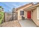 Cozy home entryway showcasing a red front door, gated courtyard, and well-maintained desert landscape at 2744 Ironside Dr, Las Vegas, NV 89108
