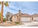 Inviting single-story home with a two-car garage, desert landscaping, and a well-manicured lawn at 2744 Ironside Dr, Las Vegas, NV 89108