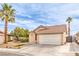 Attractive single-story home with a two-car garage, desert landscaping, and a lush palm tree at 2744 Ironside Dr, Las Vegas, NV 89108