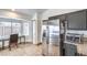 Bright kitchen with stainless steel refrigerator, granite countertops, and tile flooring with breakfast nook at 2744 Ironside Dr, Las Vegas, NV 89108