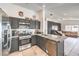 Well-lit kitchen with stainless steel appliances, gray cabinets, and an open view to the living area at 2744 Ironside Dr, Las Vegas, NV 89108
