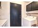 Functional laundry area featuring a washer, dryer, and storage cabinets for convenience at 2744 Ironside Dr, Las Vegas, NV 89108