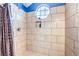 Walk-in shower featuring decorative tile, a recessed storage shelf, and rainfall shower head at 2744 Ironside Dr, Las Vegas, NV 89108